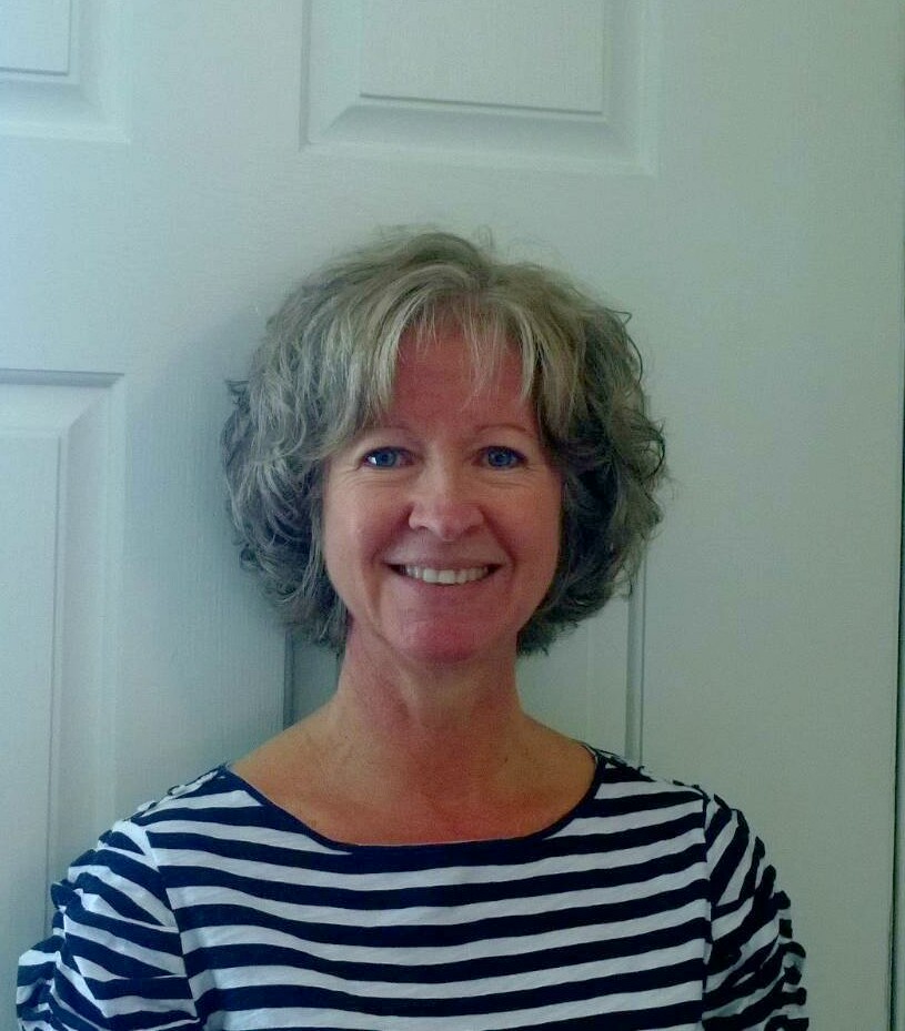 a woman standing in front of a white door