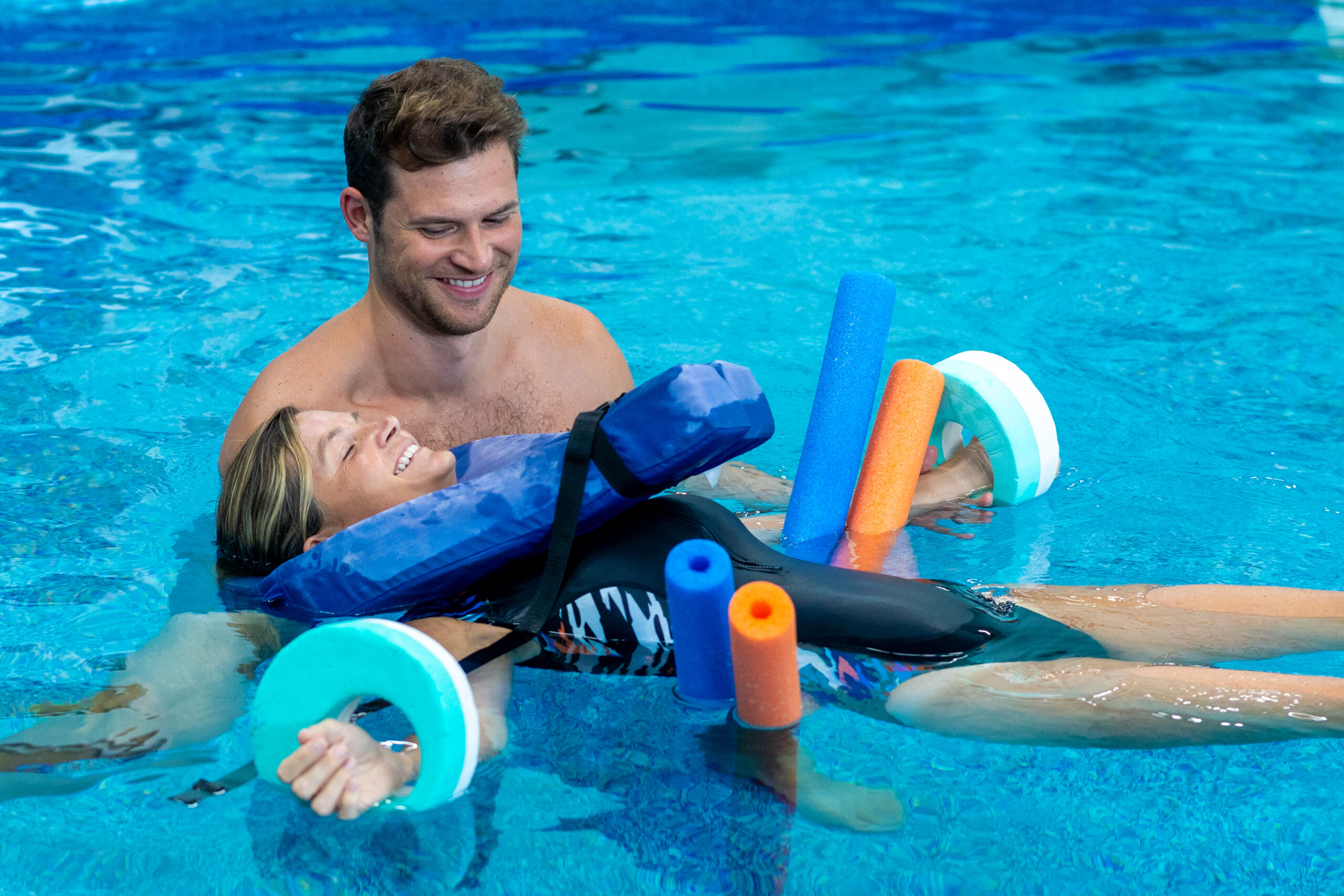 a man and a little girl are in the pool