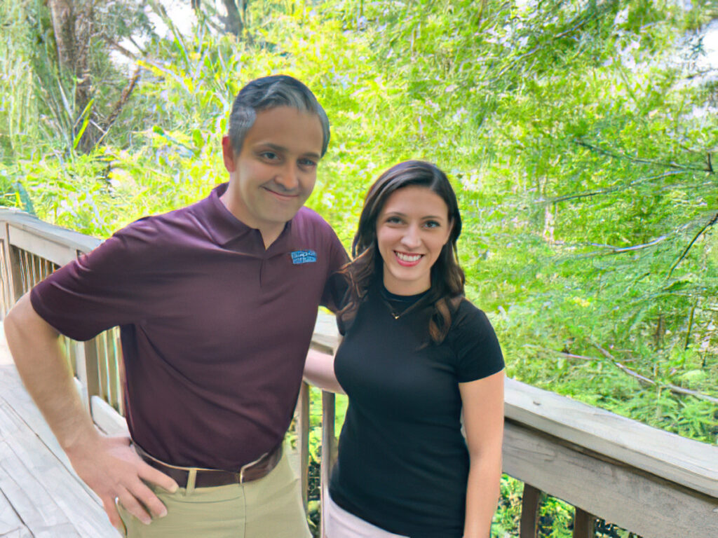 a man and a woman standing on a porch