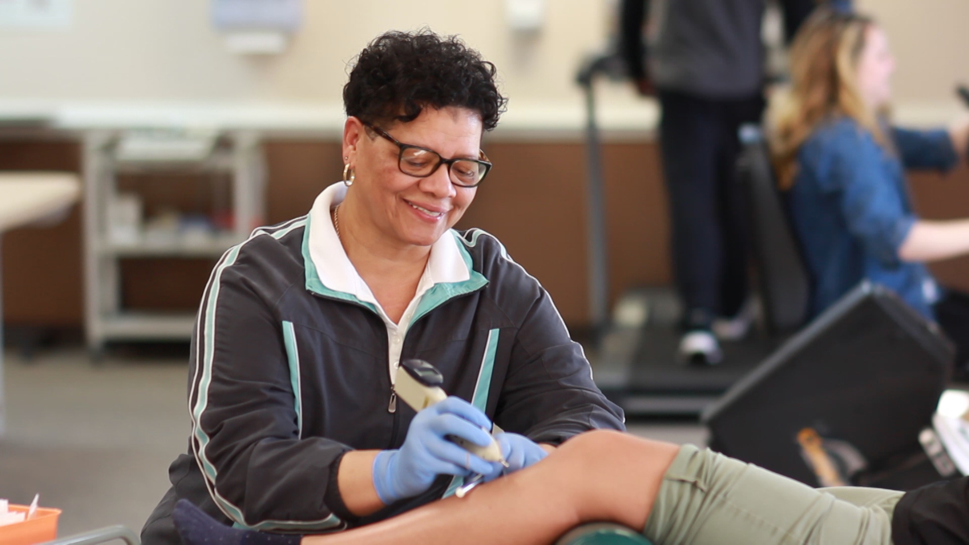 a woman getting her leg examined by a doctor
