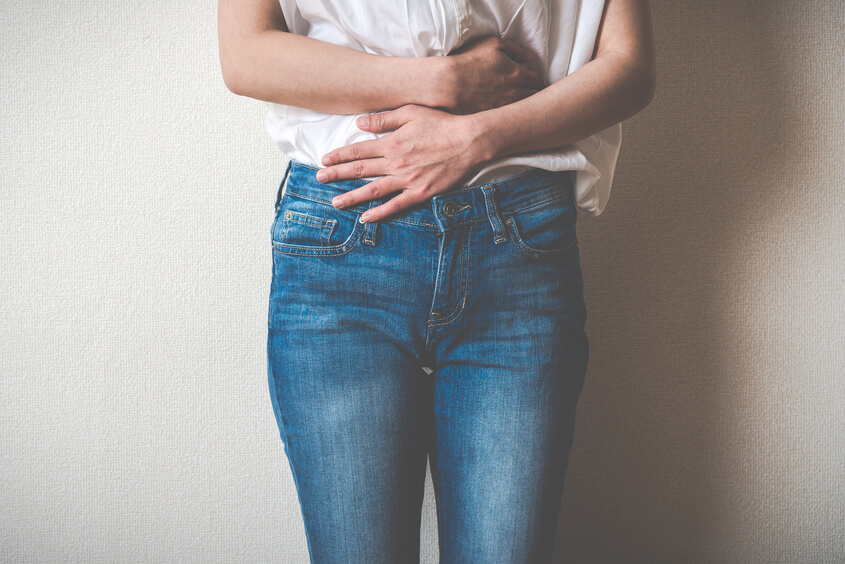 a person standing with their hands on their hips