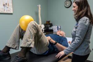 a man laying on a table with a yellow balloon on his head