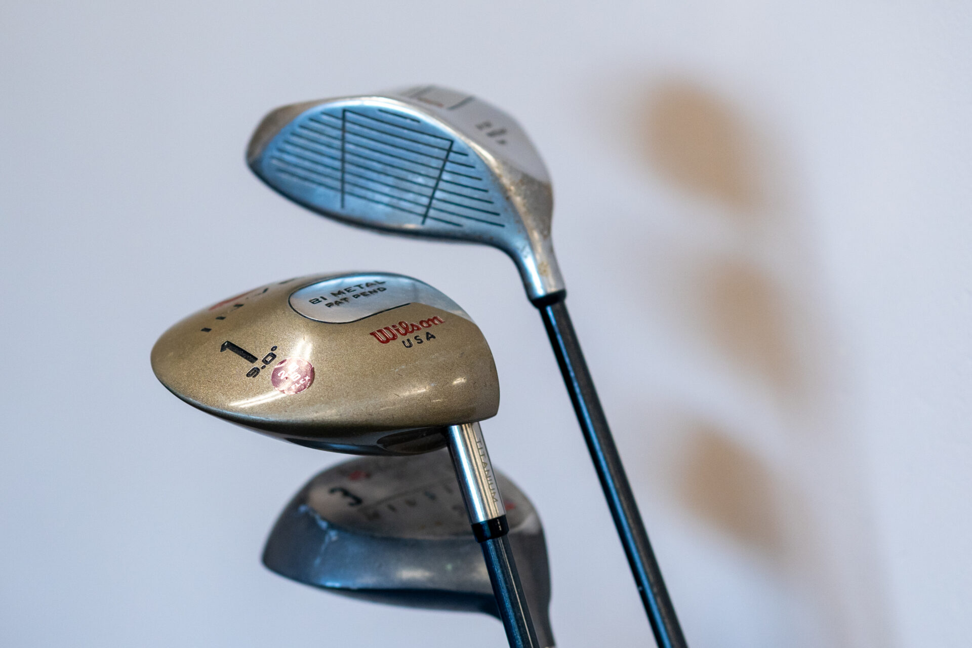 two golf clubs with the driver and driver facing each other