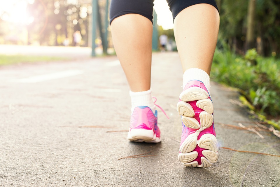 a person walking down a street with pink shoes