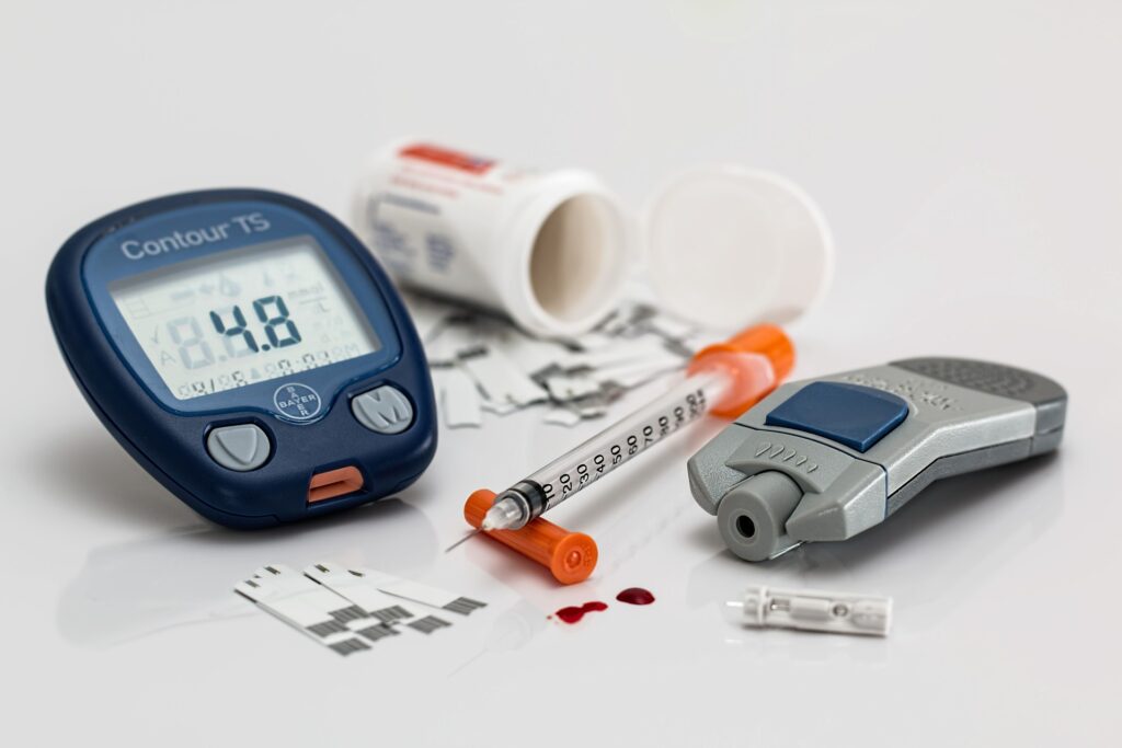 a blood test, an orange needle and some medical supplies