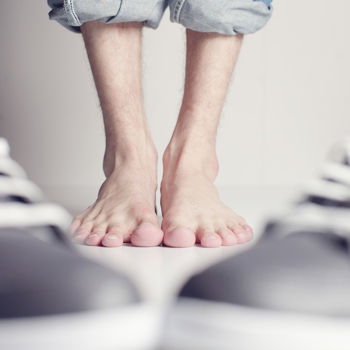 a person standing on top of a pair of shoes