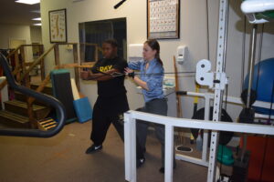 a man and woman in a gym with equipment