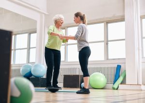 Physical therapist working with a patient who has osteoporosis
