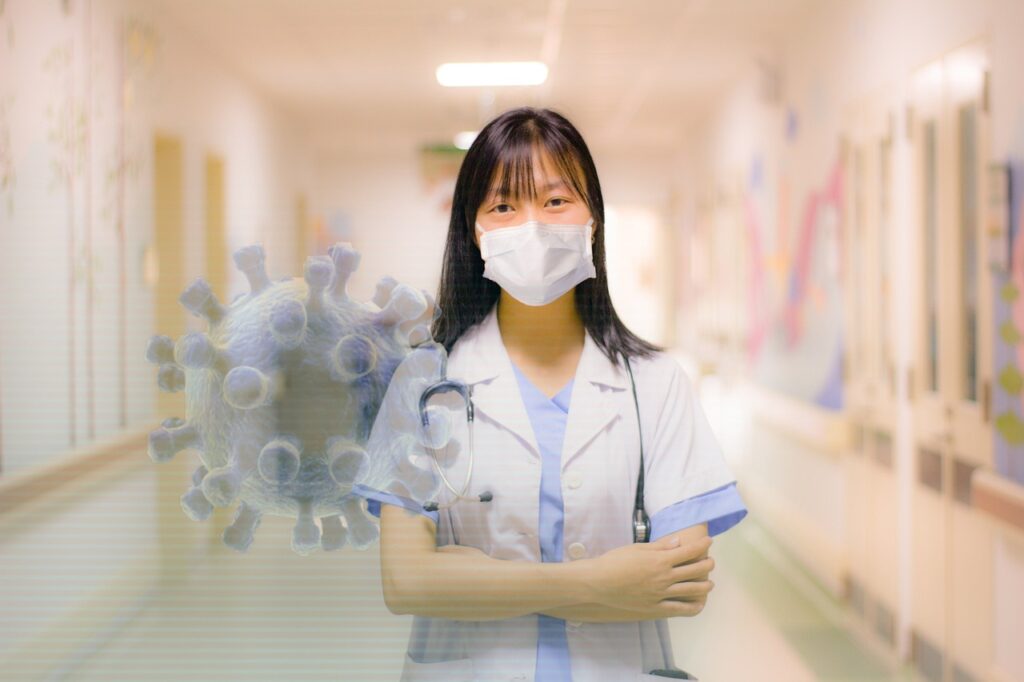a woman wearing a face mask and holding a medical instrument