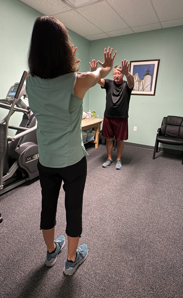 a woman and a boy are in a gym